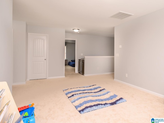 sitting room featuring light carpet