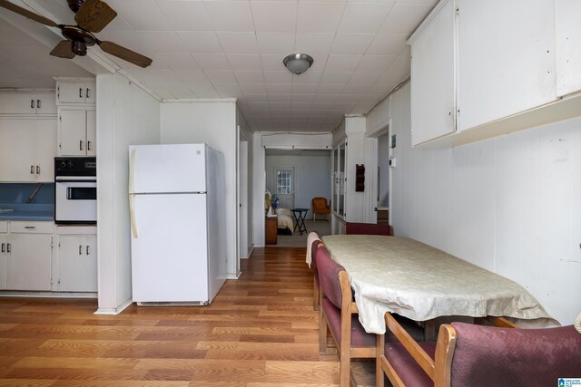 kitchen featuring white cabinets, white appliances, ceiling fan, and light hardwood / wood-style floors