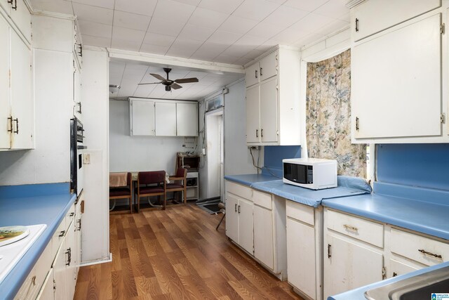 kitchen with white cabinets, ceiling fan, dark hardwood / wood-style flooring, and wall oven