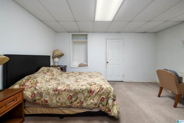 bedroom with carpet and a drop ceiling