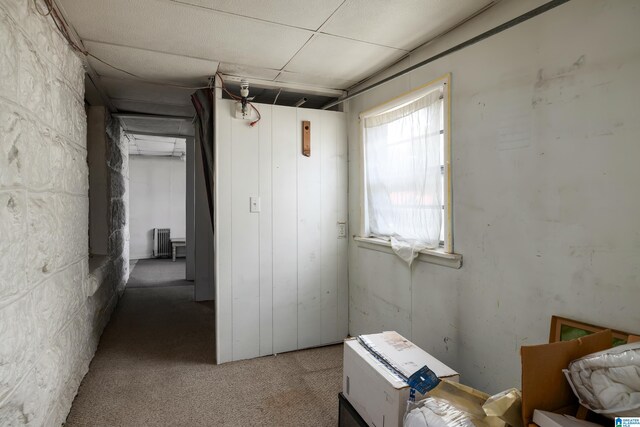 interior space featuring carpet flooring and radiator heating unit