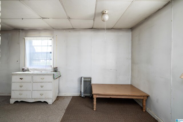 miscellaneous room featuring radiator, a paneled ceiling, and carpet flooring