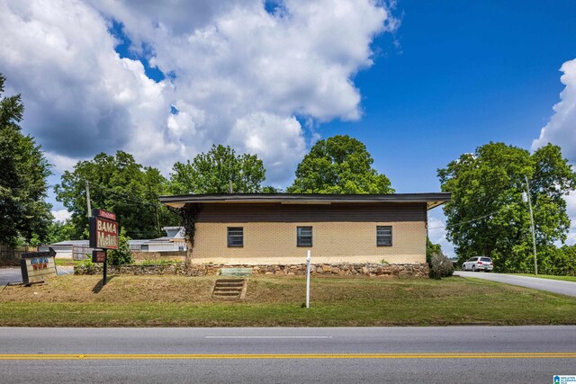 view of side of home with a lawn