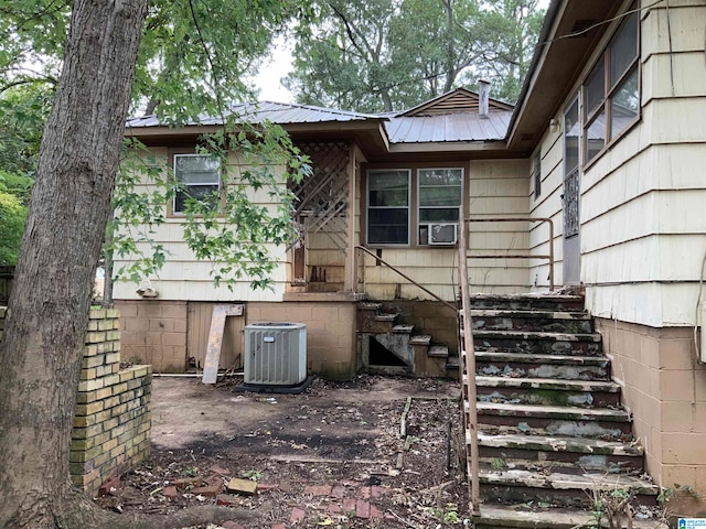 rear view of property featuring cooling unit and central AC unit