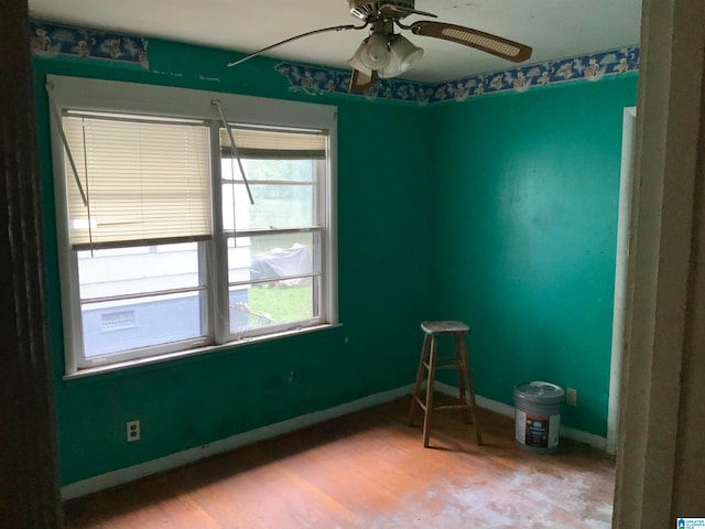 empty room with ceiling fan and hardwood / wood-style floors