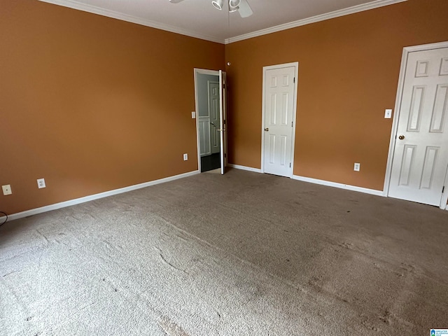 carpeted spare room featuring crown molding and ceiling fan