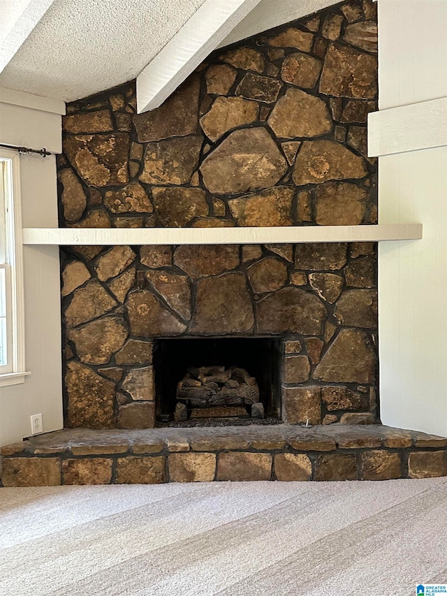 room details featuring a fireplace, a textured ceiling, and carpet flooring