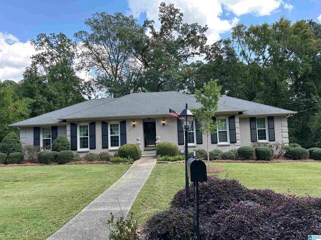 ranch-style home with a front lawn