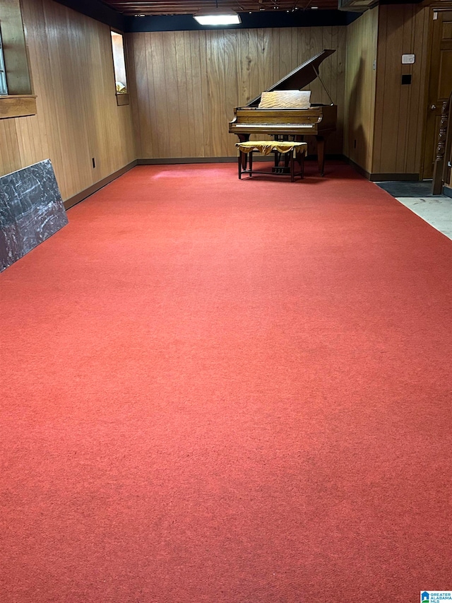 basement with carpet floors and wood walls