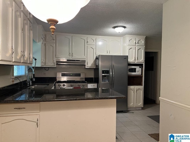 kitchen featuring light tile patterned floors, appliances with stainless steel finishes, a peninsula, under cabinet range hood, and a sink