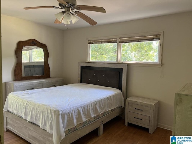 bedroom with ceiling fan and wood finished floors