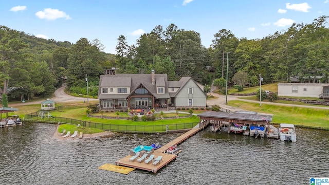 dock area featuring a water view and a lawn