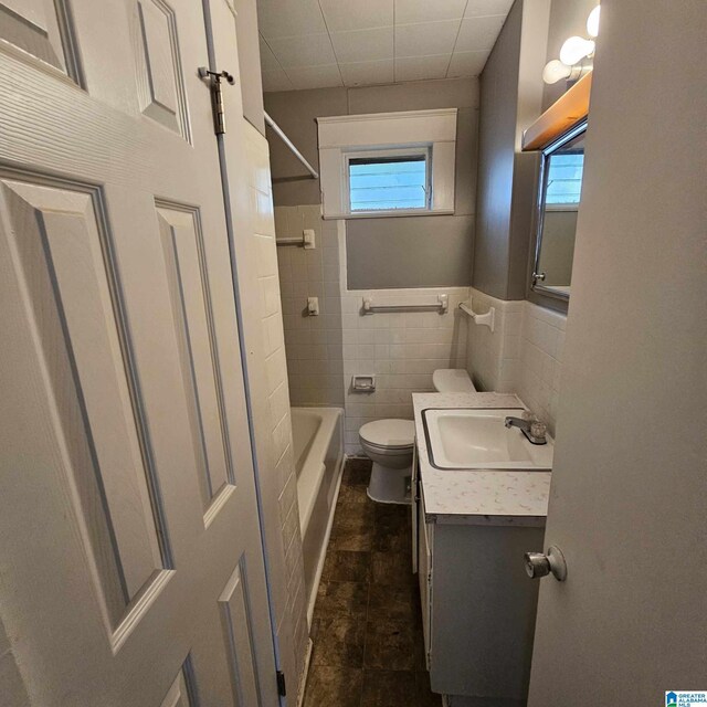 full bathroom with vanity, toilet, plenty of natural light, and shower / bath combination