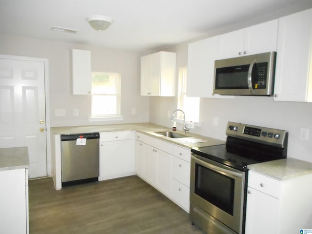 kitchen featuring dark hardwood / wood-style flooring, stainless steel appliances, sink, and white cabinets