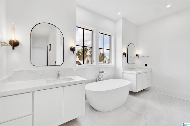 bathroom with a tub to relax in and vanity