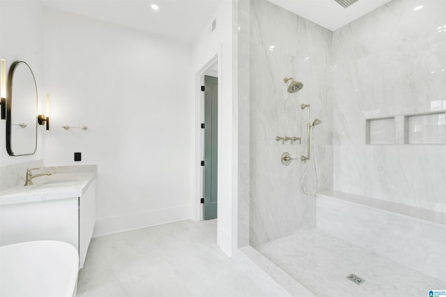 bathroom with vanity and a tile shower