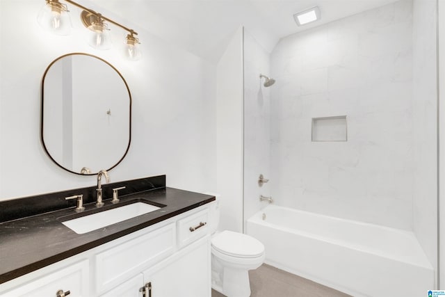 full bathroom with tile patterned floors, tiled shower / bath, toilet, and vanity