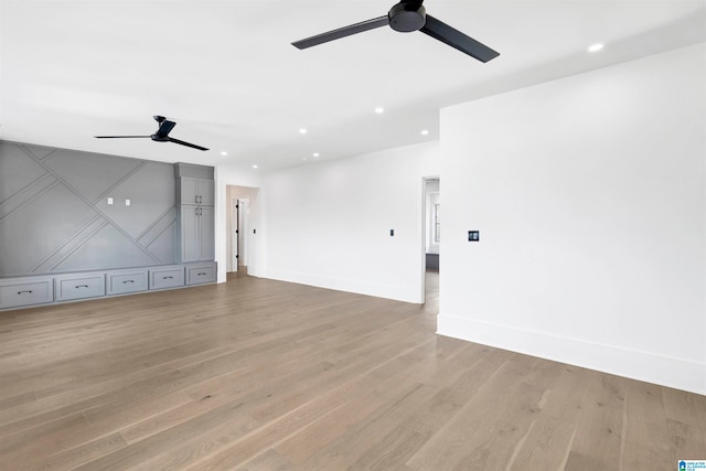 interior space with light wood-type flooring and ceiling fan