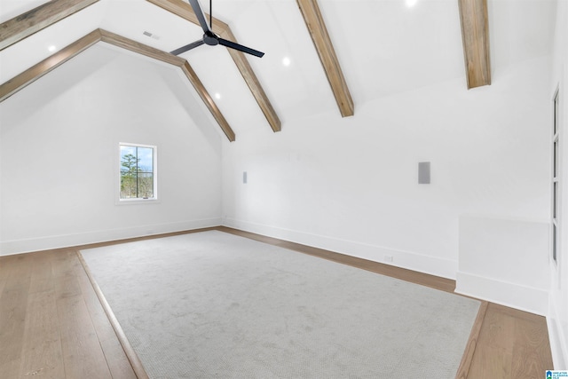 interior space featuring wood-type flooring and lofted ceiling with beams