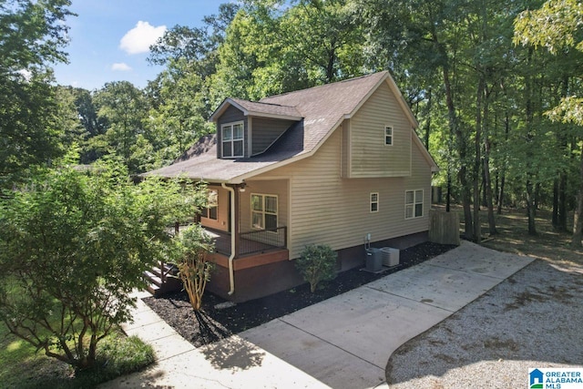 view of home's exterior featuring cooling unit and covered porch