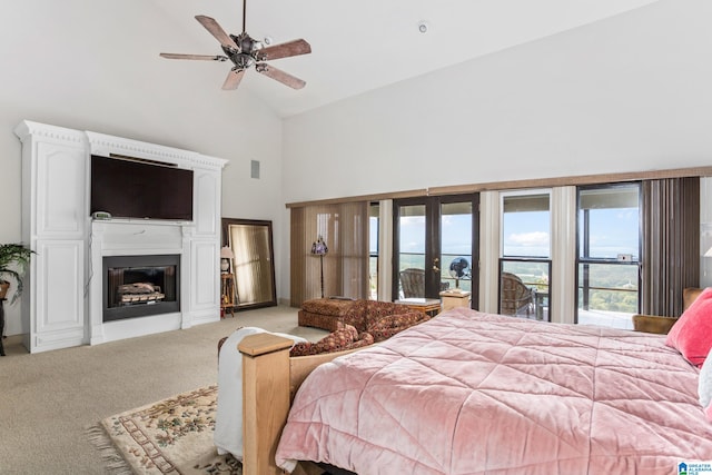 bedroom featuring ceiling fan, access to exterior, light carpet, and high vaulted ceiling