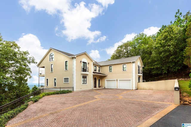 view of front of home featuring a garage and a balcony