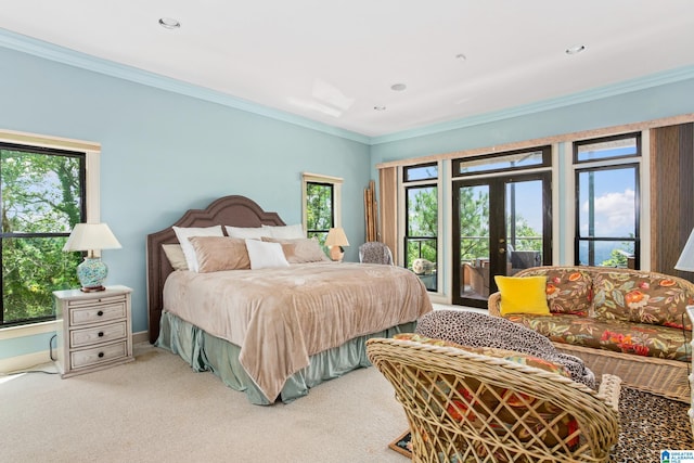 carpeted bedroom featuring access to outside, multiple windows, and french doors