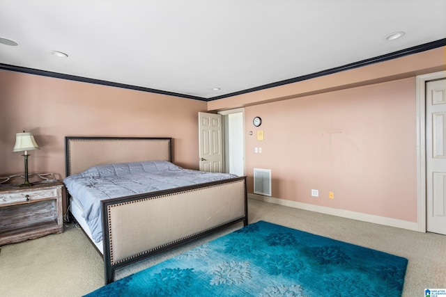 bedroom with carpet floors and crown molding