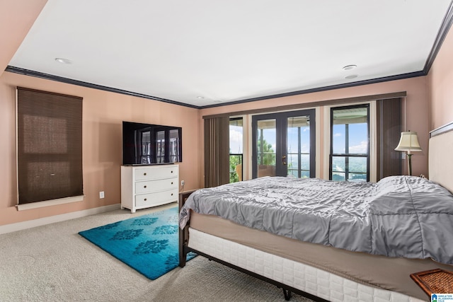 carpeted bedroom featuring multiple windows, crown molding, and french doors