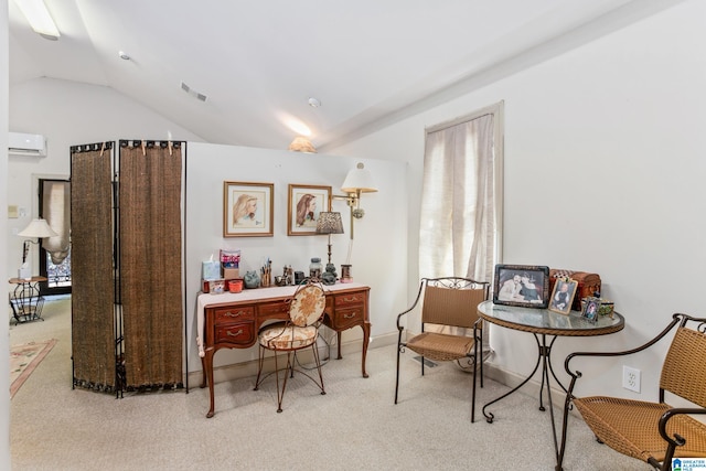 sitting room featuring an AC wall unit, light colored carpet, and vaulted ceiling