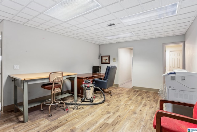 office with a paneled ceiling and light wood-type flooring