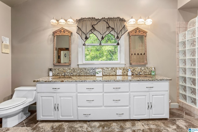 bathroom featuring tile patterned floors, vanity, and toilet