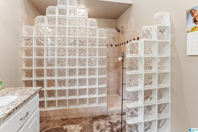 bathroom featuring vanity and a tile shower