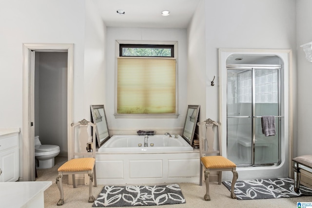 full bathroom featuring vanity, independent shower and bath, and toilet