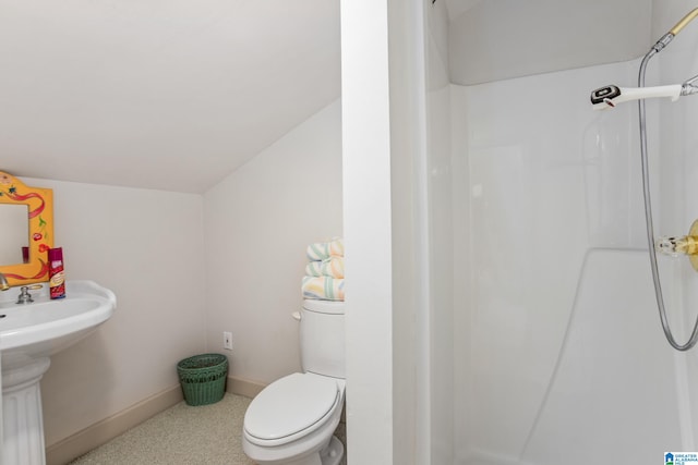 bathroom featuring walk in shower and toilet