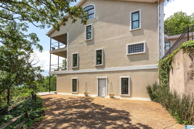 back of house featuring a balcony