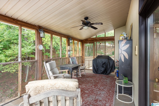 sunroom with plenty of natural light, ceiling fan, wood ceiling, and vaulted ceiling