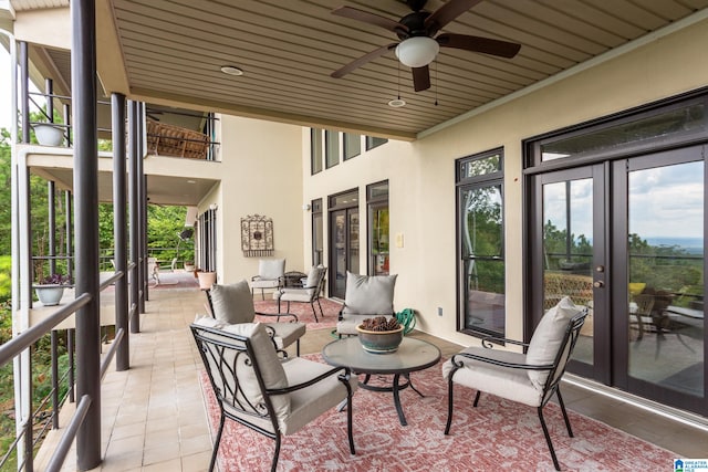 sunroom with ceiling fan, wooden ceiling, and french doors