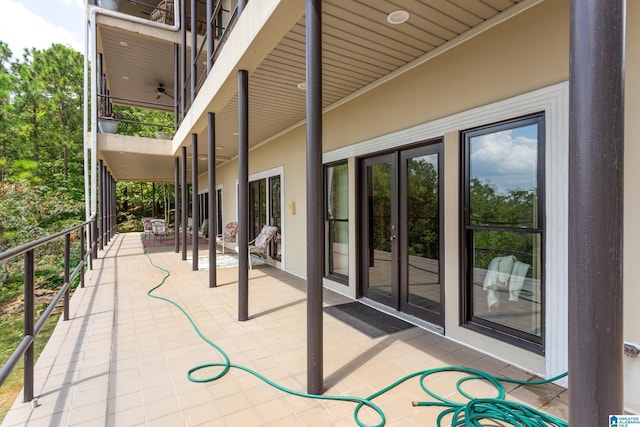 view of patio / terrace with ceiling fan and a balcony