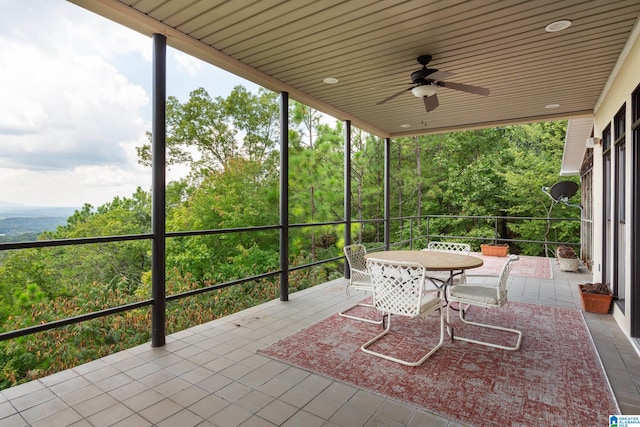 unfurnished sunroom with ceiling fan and wooden ceiling