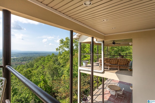 exterior space with wood ceiling, ceiling fan, and a healthy amount of sunlight