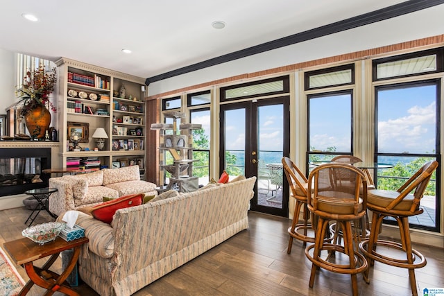 living room featuring french doors, dark hardwood / wood-style floors, and ornamental molding