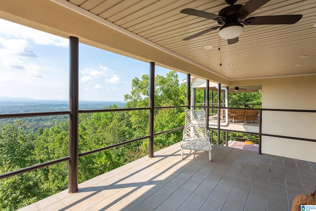 unfurnished sunroom featuring ceiling fan and wooden ceiling