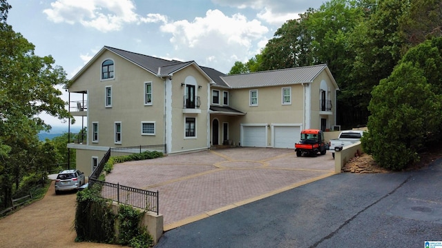 view of front of home featuring a balcony and a garage