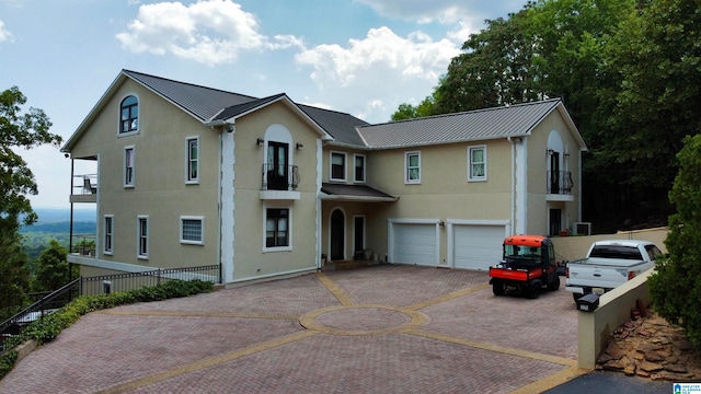 view of front of house with a garage and a balcony