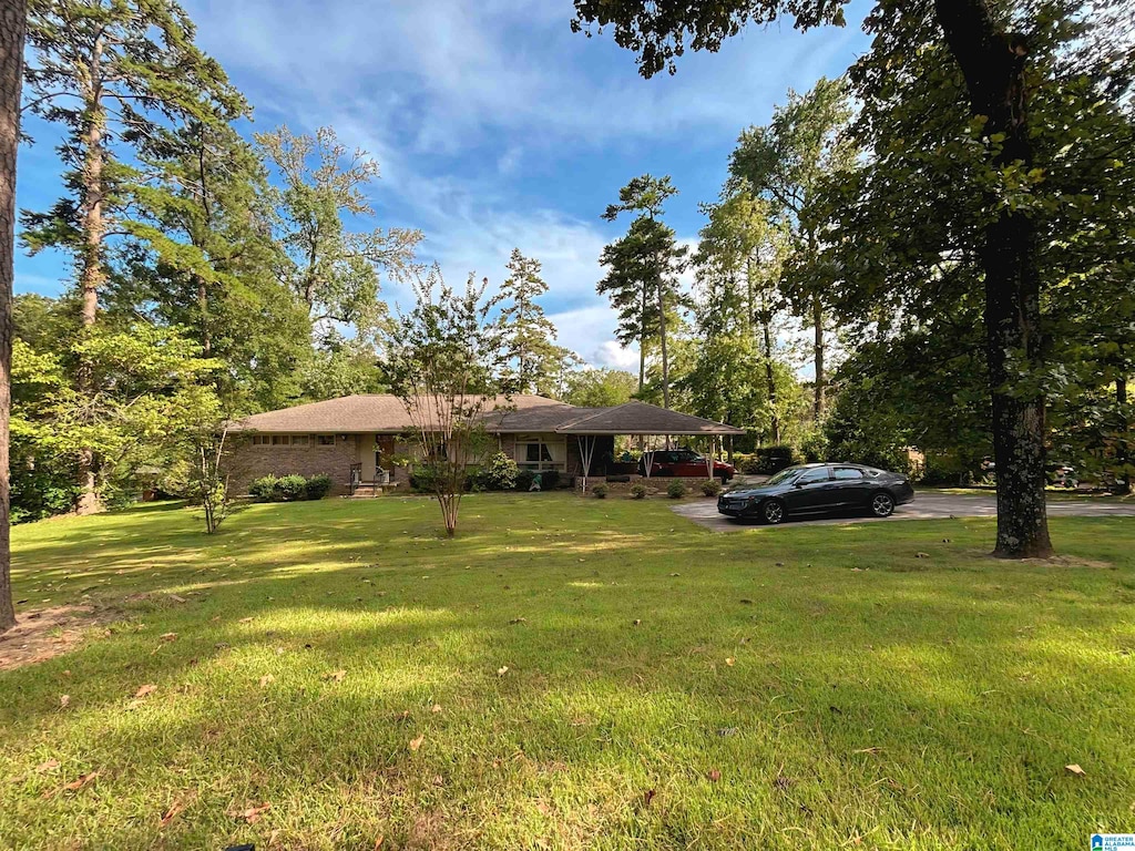 view of front facade with a front lawn and a carport