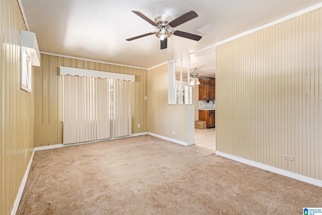 carpeted spare room with ornamental molding, plenty of natural light, and ceiling fan