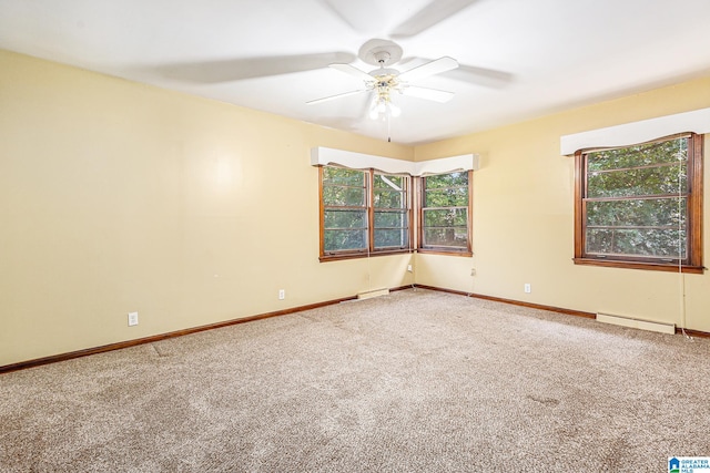 empty room with a baseboard heating unit, ceiling fan, and carpet