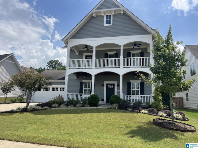 view of front of property featuring a front lawn, ceiling fan, covered porch, and a garage