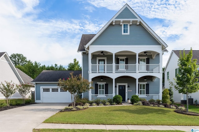 view of front of property featuring a balcony, ceiling fan, covered porch, and a front lawn